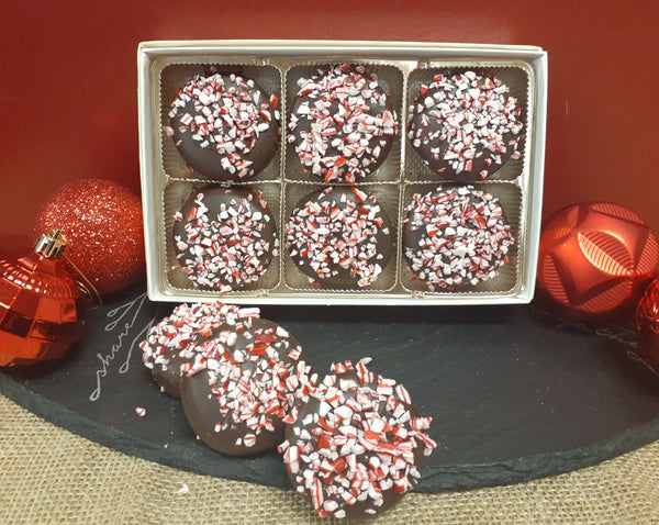 Mint Oreo cookie dipped in dark chocolate and topped with crumbled candy canes.  